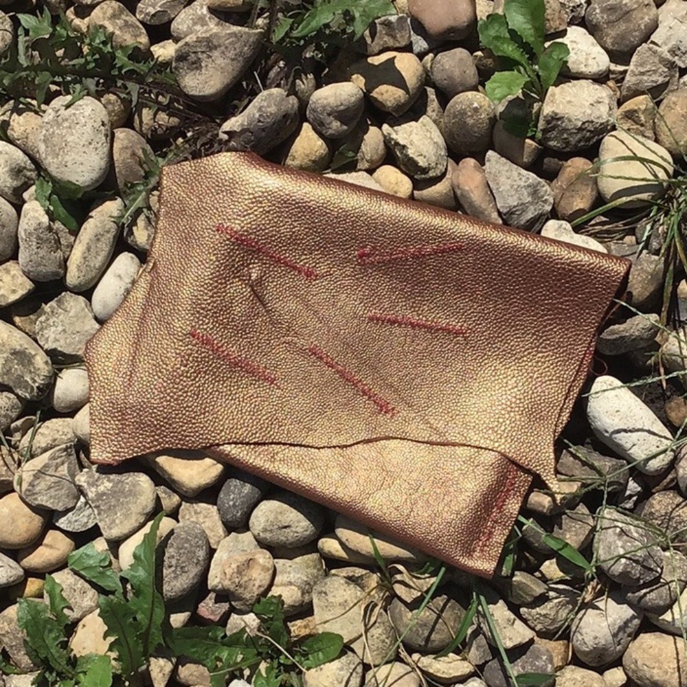 Leather clutch in metallic brown.